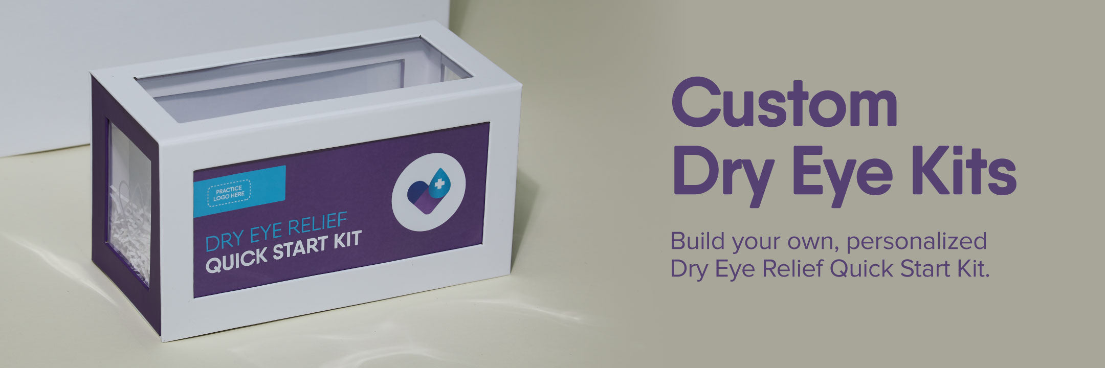 Box labeled Dry Eye Relief Quick Start Kit with a heart icon, placed on a table. Text on the right reads, Custom Dry Eye Kits - Build your own, personalized Dry Eye Relief Quick Start Kit. Background is a neutral shade.