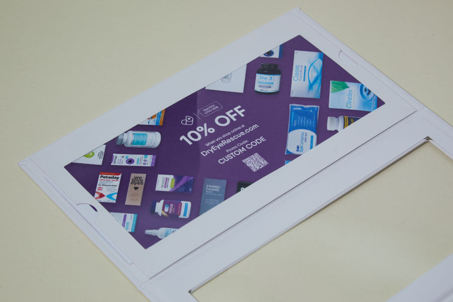 A promotional flyer offers 10% off at DryEyeRescue.com using the code CUSTOMCODE. The flyer features a variety of eye care products around the text on a light-colored background.