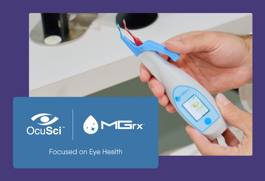 Close-up of hands holding a white and blue handheld medical device with a small screen. The background shows part of a machine. A blue graphic reads OcuSci, MGrx, and Focused on Eye Health.