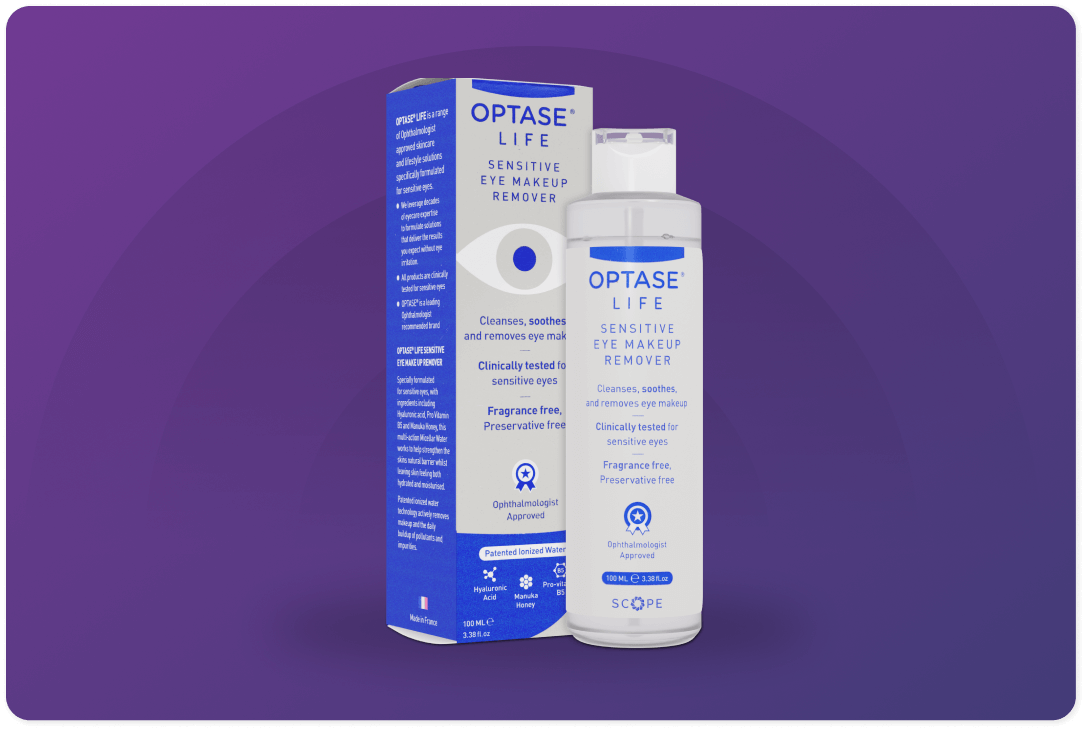 Image of Optase Life Sensitive Eye Makeup Remover against a purple background. The product packaging highlights features such as being fragrance-free, preservative-free, and suitable for sensitive eyes.