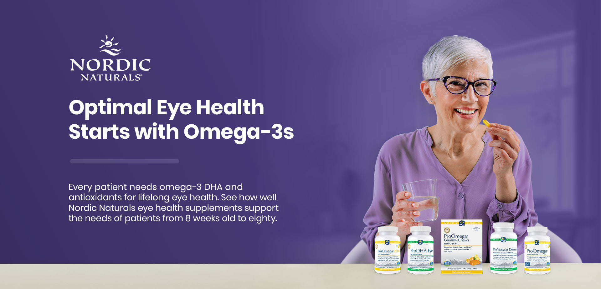 An elderly woman with short white hair and glasses is sitting at a table, smiling and holding a supplement. In front of her are several bottles of Nordic Naturals supplements. Text promotes eye health benefits of omega-3s. The background is purple.