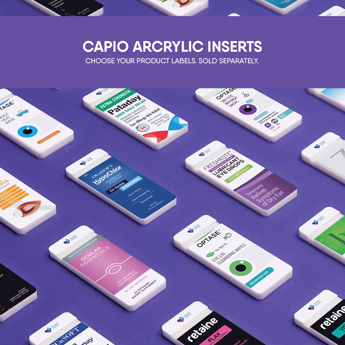 The image shows a selection of DryEye Rescues Capio™ System Display Acrylic Inserts on a purple surface. Each insert features distinct label designs and colors, showcasing various product options. Bold text above states Capio Acrylic Inserts, ideal for enhancing dry eye discussions.