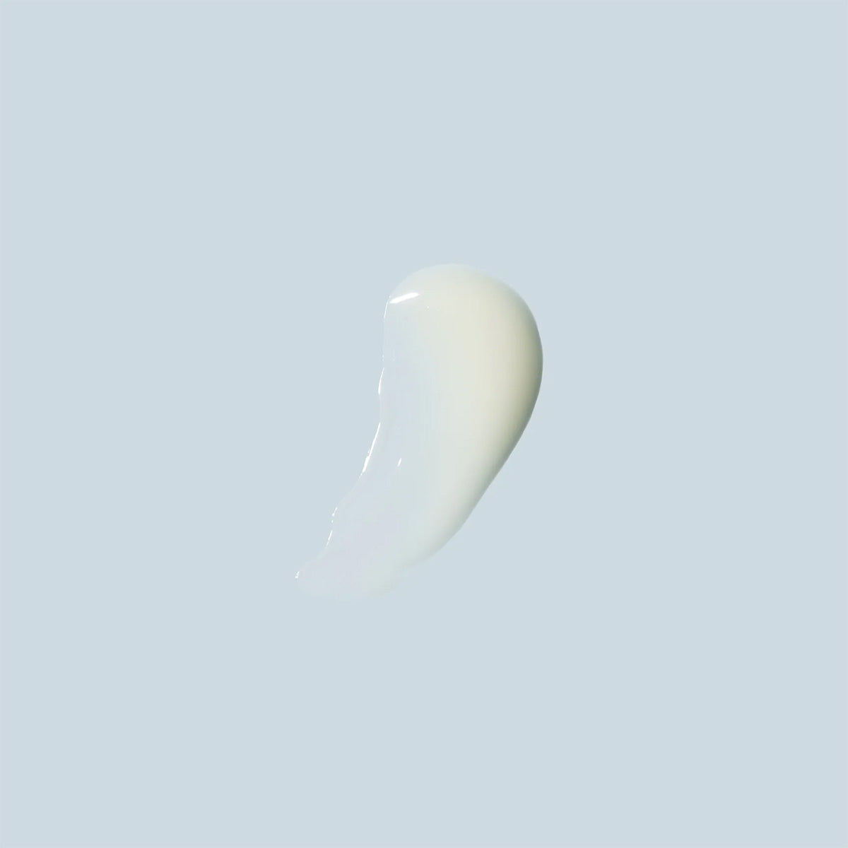 A smooth, creamy white smear of Daily Practice Firm & Restore Eye Cream against a light gray background showcases its glossy texture, ideal for hydrating delicate areas and reducing fine lines.