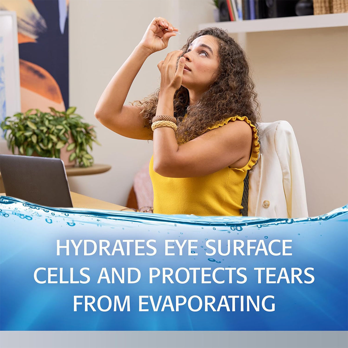 A woman in a yellow sleeveless top uses Abbvies Refresh Optive® Advanced Preservative-Free Lubricant Eye Drops (30 Single-Use Vials) at her desk with a laptop nearby. Her jacket drapes the chair as she hydrates eye cells and prevents tear evaporation, ensuring Dry Eye Comfort.