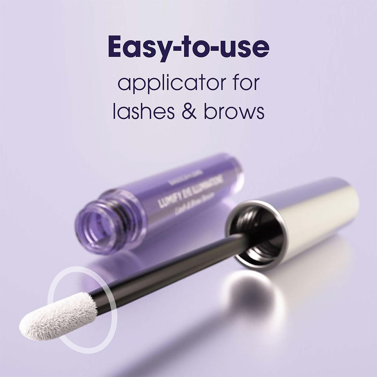 A close-up of the LUMIFY Eye Illumination Serum tube, featuring a silver lid and white brush tip. Text reads, Easy-to-use applicator for fuller lashes & brows. This Bausch + Lomb nourishing serum provides clinically proven results, set against a soft lilac background.