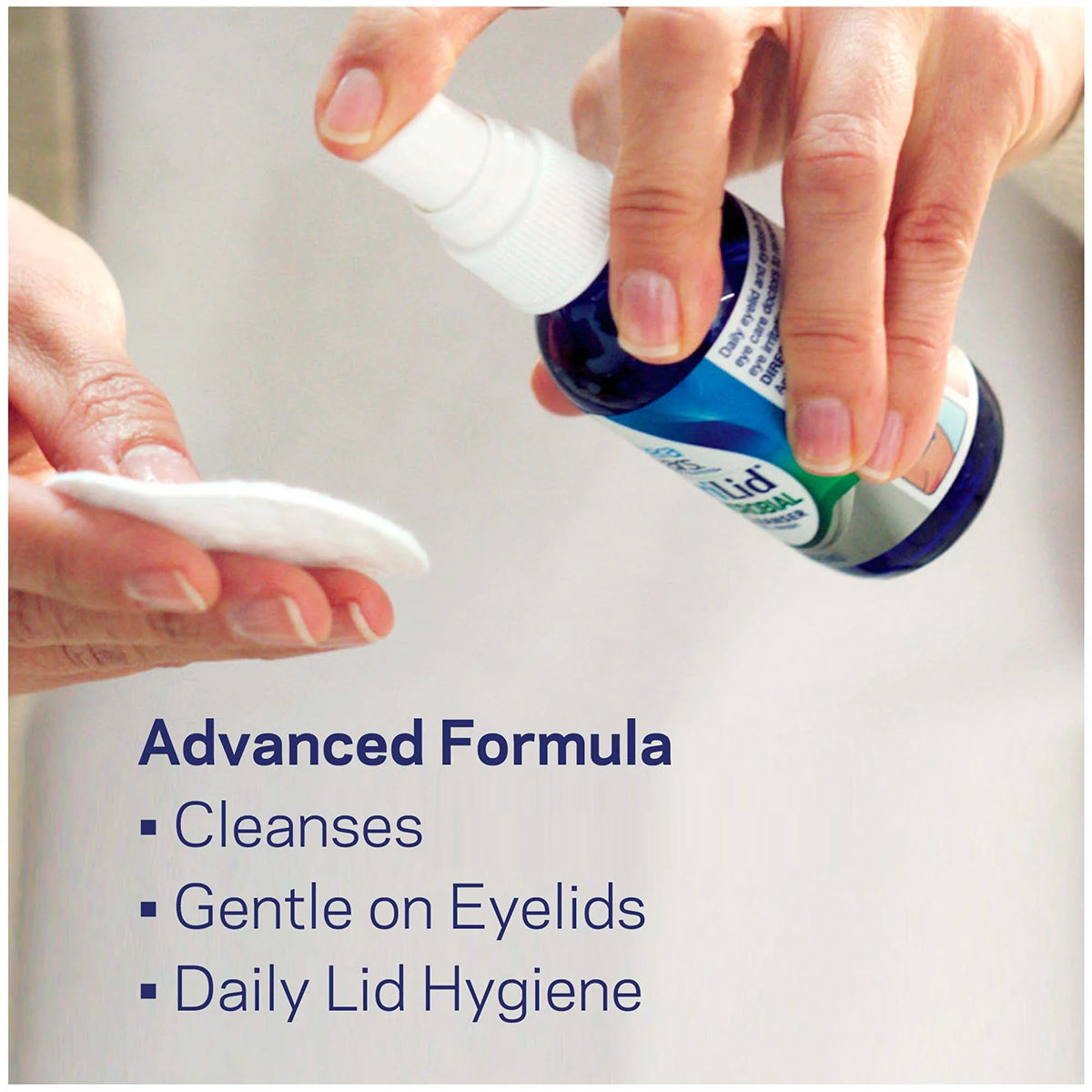 A person sprays a blue TheraTears SteriLid Antimicrobial Eyelid Cleanser bottle onto a cotton pad. The text reads: Advanced Formula, with points: Cleanses with hypochlorous acid, Gentle on Eyelids, Enhances Ocular Health, and Daily Lid Hygiene.
