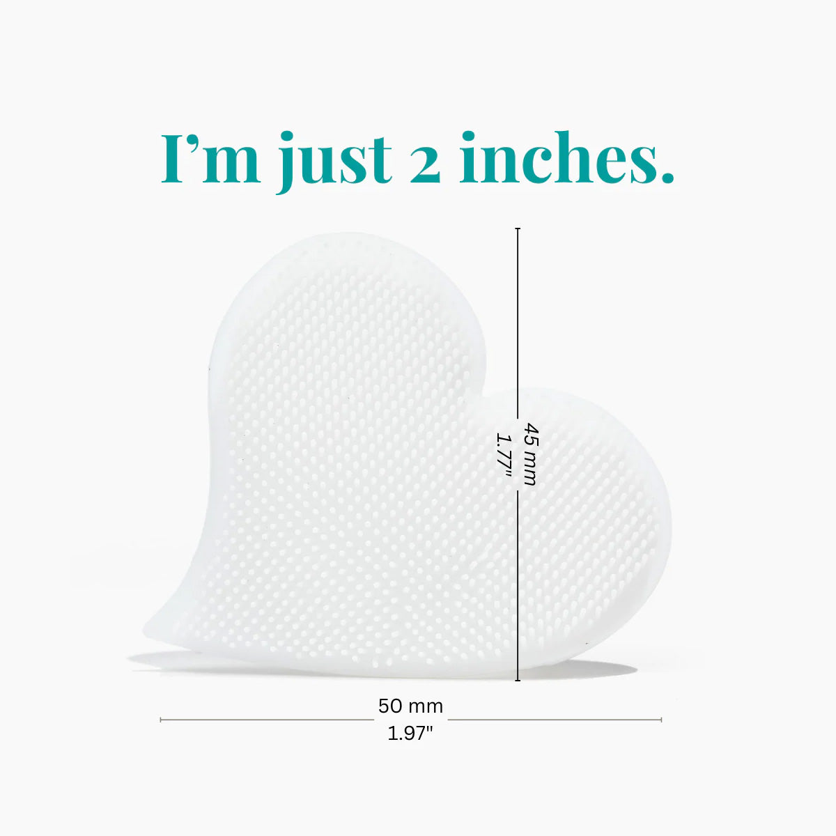 The We Love Eyes Mini Eyelid Scrub Mitt is a heart-shaped object with a textured surface, measuring 45 mm by 50 mm, inscribed with Im just 2 inches, and designed for precision cleansing with its gentle design.