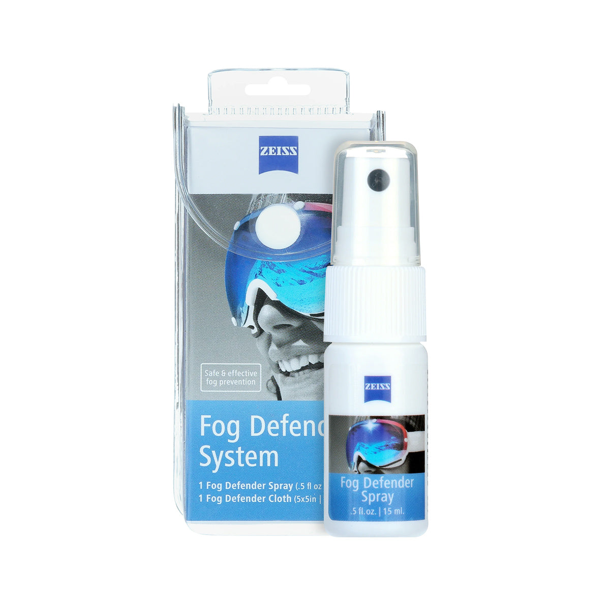A small white spray bottle labeled ZEISS Fog Defender System sits before its box, which shows a goggle-wearing person with a helmet. This 0.5 fl. oz. Zeiss anti-fog spray ensures clear vision on ZEISS lenses in any condition and comes with a microfiber cloth.