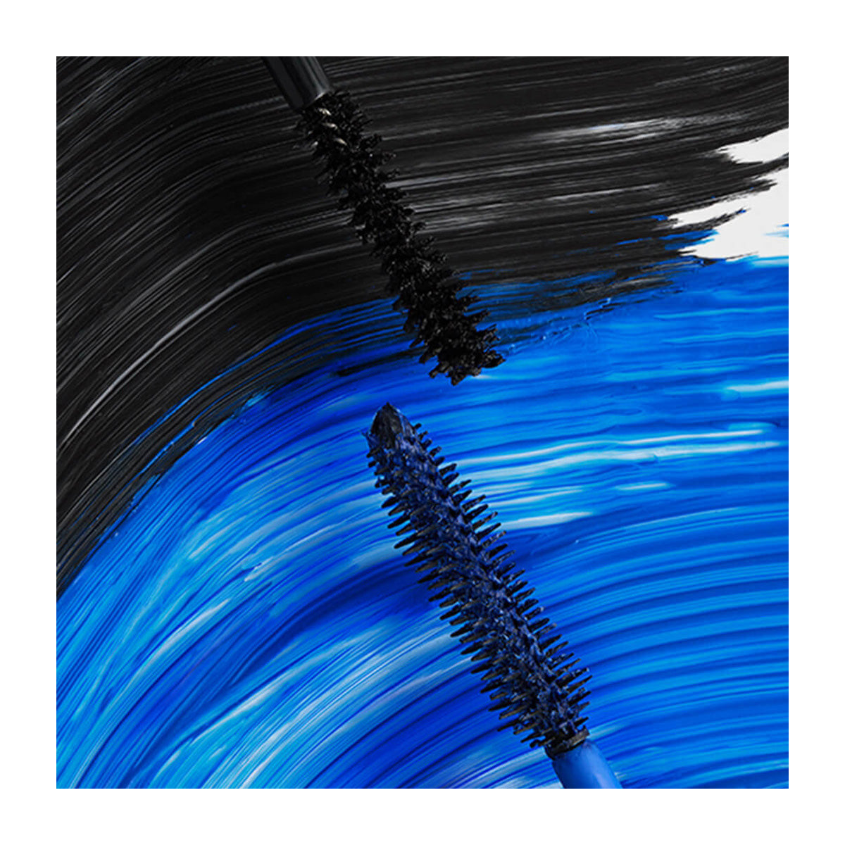 Two mascara brushes from the RevitaLash Double-Ended 2-in-1 Lash Primer & Mascara Volume Set are shown against black and blue streaks. The top brush creates bold black strokes, while the bottom brush delivers vibrant blue strokes, highlighting a striking contrast.