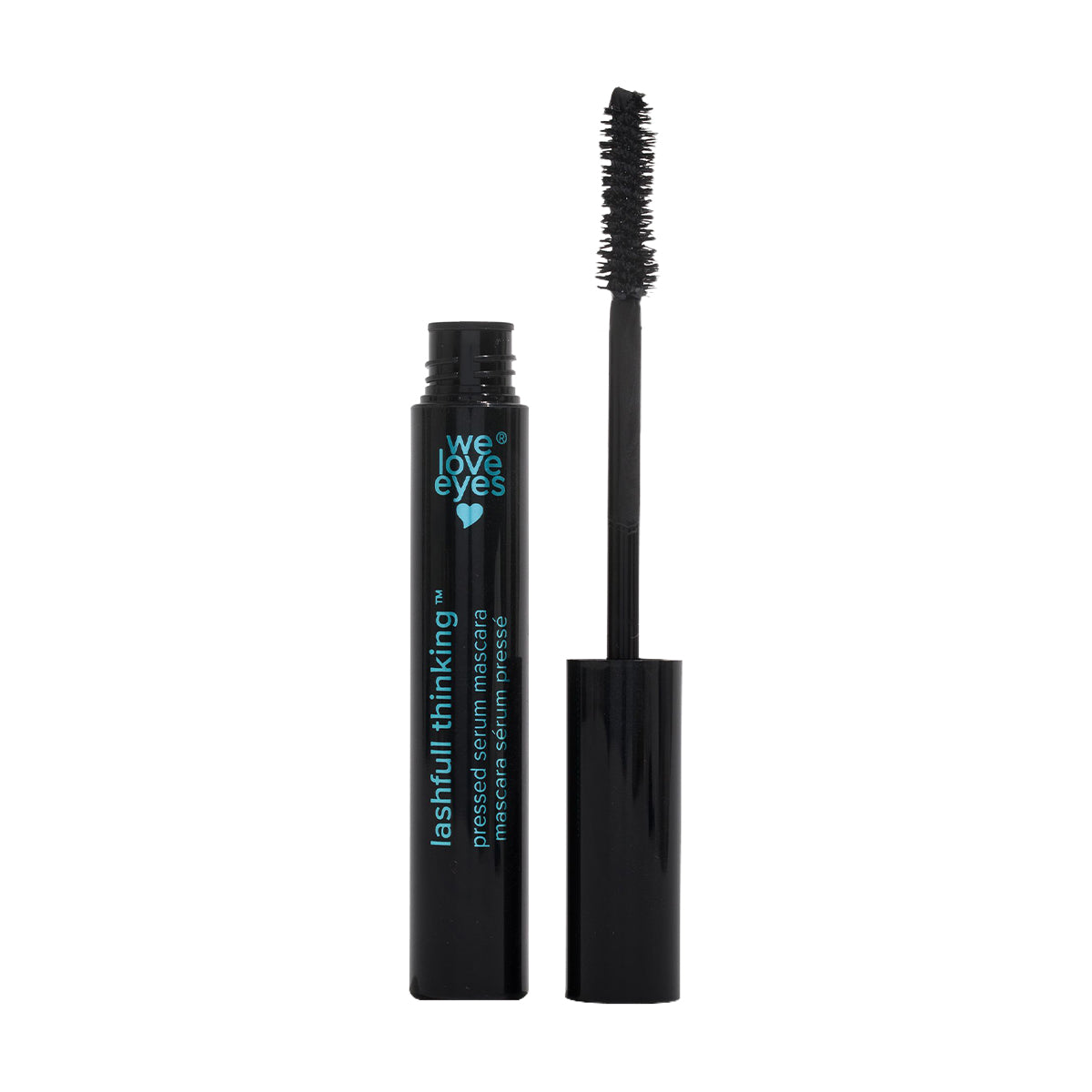 A black mascara tube with turquoise text reading lashfull thinking and featuring a small heart and we love eyes. The cap is removed, revealing the volumizing We Love Eyes Lashfull Thinking BLACK Pressed Serum Mascara wand on a white background.