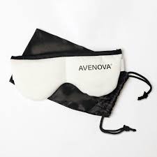 The Avenova Microwavable Heat Eye Compress Mask by NovaBay, ideal for blepharitis relief, features a reusable white design with black trim and comes with a black silk drawstring pouch for easy storage.