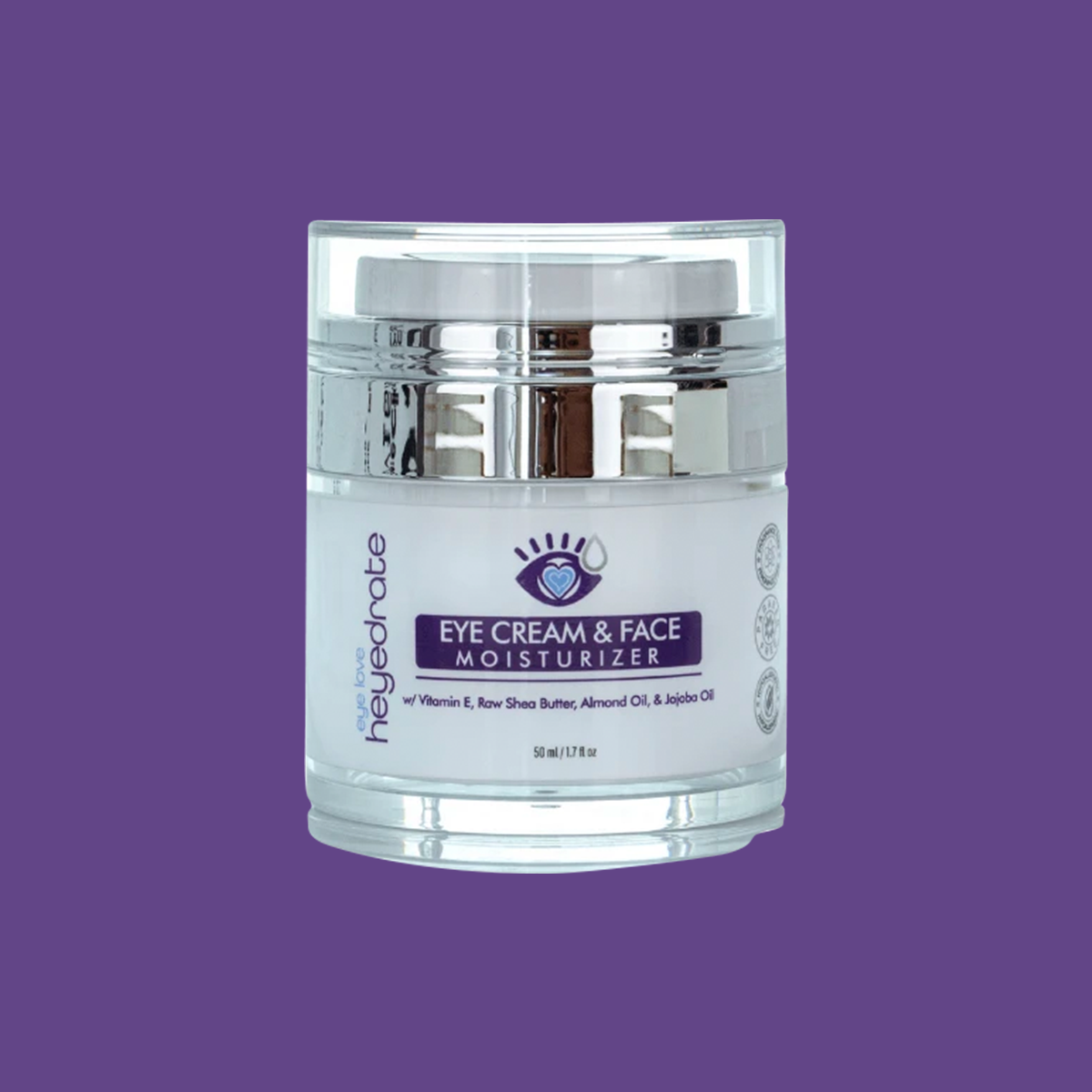 A jar of Heyedrate Eye Cream and Face Moisturizer by PRN - Physician Recommended Nutriceuticals is set against a purple backdrop. The white label, trusted by optometrists, showcases its ingredients: Vitamin E, Raw Shea Butter, Almond Oil, and Jojoba Oil. A sleek silver lid tops the design.