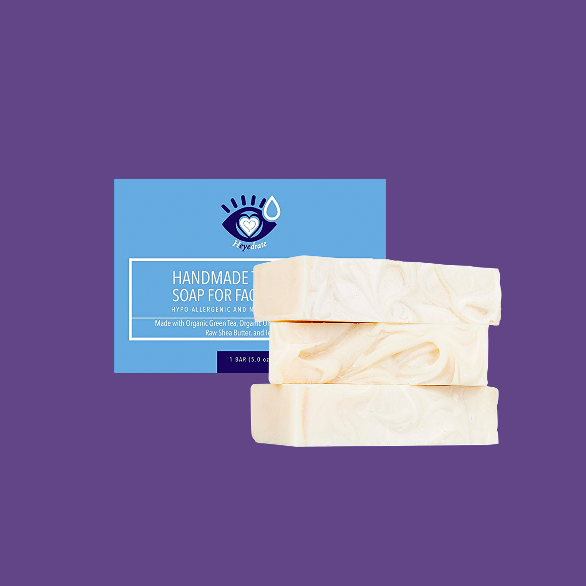 Three Heyedrate Tea Tree Oil Face Soap bars from PRN, highlighted for hypoallergenic and organic properties, are stacked on a purple backdrop. Behind them is blue packaging labeled as a handmade soap and eyelid scrub infused with organic ingredients.