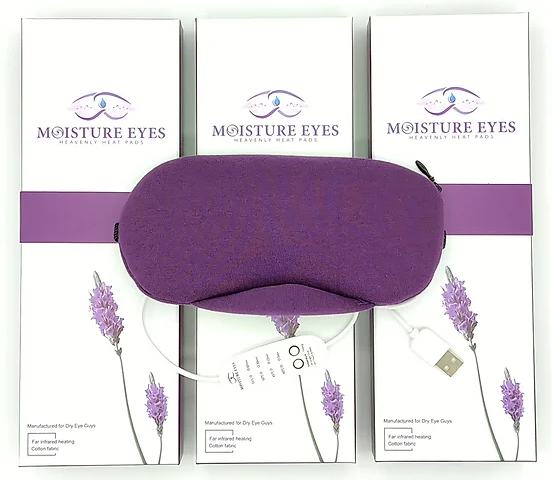 The Dry Eye Guys Moisture Eyes Heavenly Heat Pads with Infrared Technology USB Powered Mask rests atop three boxes of the same product, adorned with lavender illustrations, offering heated relief and comfort.