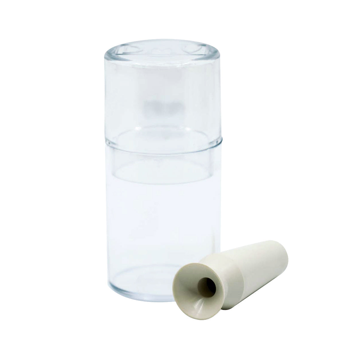 Beside it sits a clear, cylindrical container with a removable, transparent lid, perfect for storing items like contact lenses. Next to the container is a white DMV Vented Scleral Cup Contact Lens Insertion and Removal Tool, reminiscent of a vented scleral cup. The container seems empty.