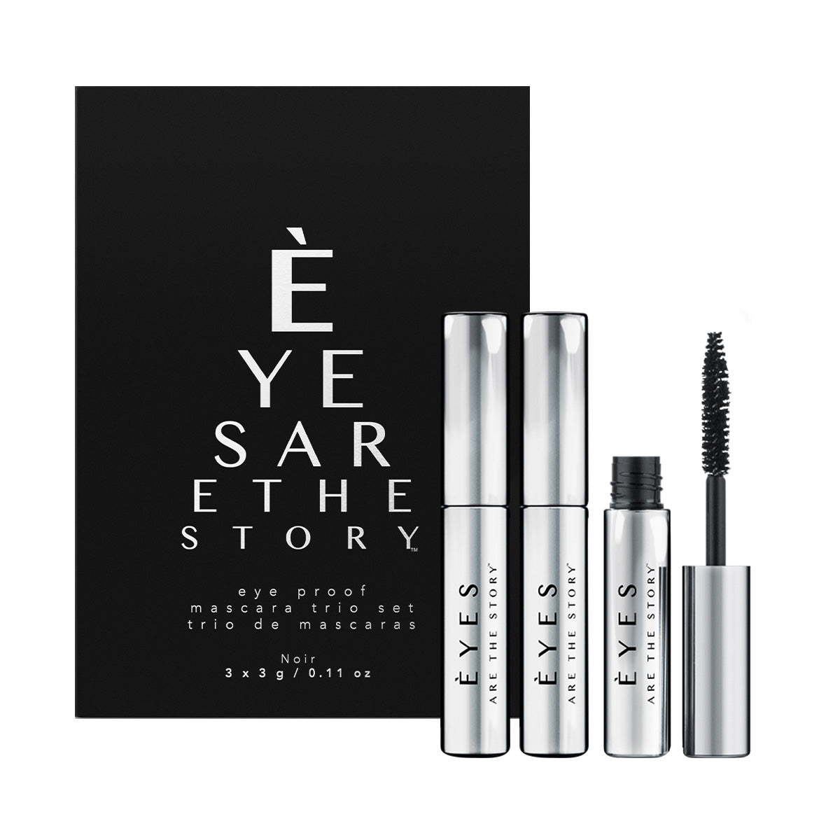 A trio of sleek silver mascara tubes with black brushes, labeled EYES ARE THE STORY and eye proof mascara trio, displayed against a white-black backdrop. This non-flaking mini mascara set is an essential beauty item for sensitive eyes.