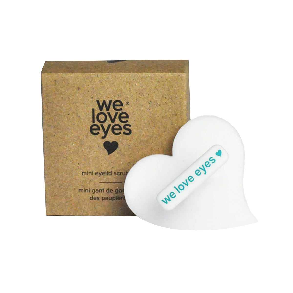 A heart-shaped white package and a brown box, both with the we love eyes label and heart symbol, hold the We Love Eyes Mini Eyelid Scrub Mitt for precise eyelid cleansing and optimal hygiene.