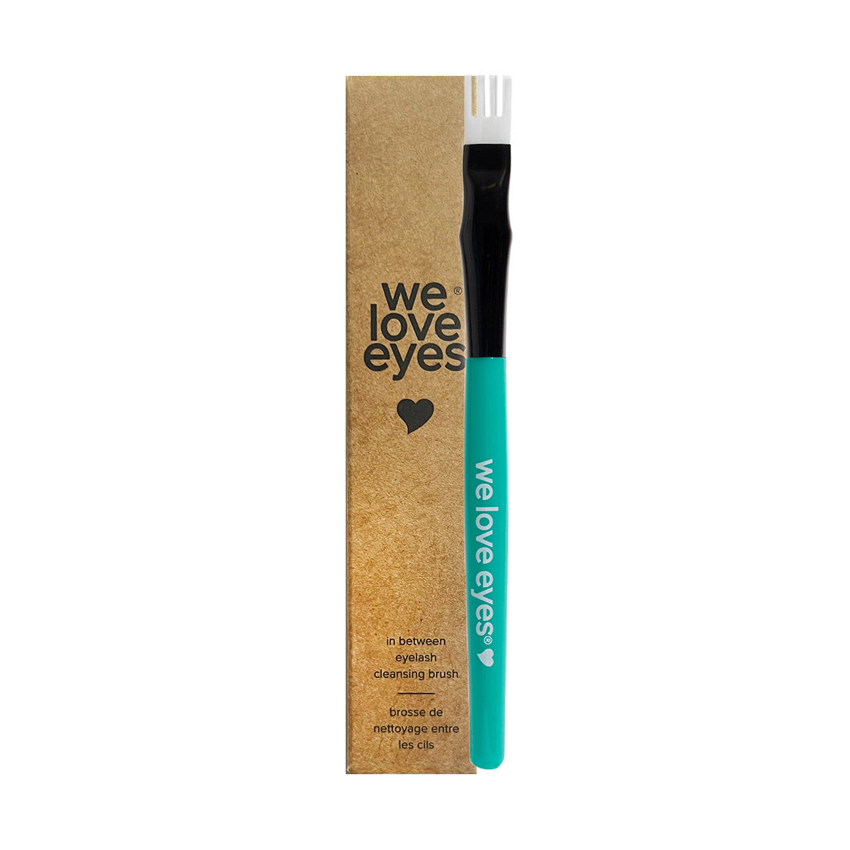 A teal and black fork-shaped eyelash cleansing brush featuring we love eyes rests beside its brown box, which displays the We Love Eyes logo and highlights it as the perfect tool for cleaning your eyelash margin.