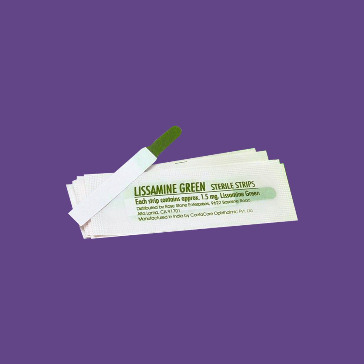 A pack of Lacriveras Green Glo Lissamine Green Ophthalmic Strips, perfect for cornea staining, is displayed against a purple background. The top sterile strip is slightly exposed, showing its green tip. The packaging bears product details and manufacturing info.